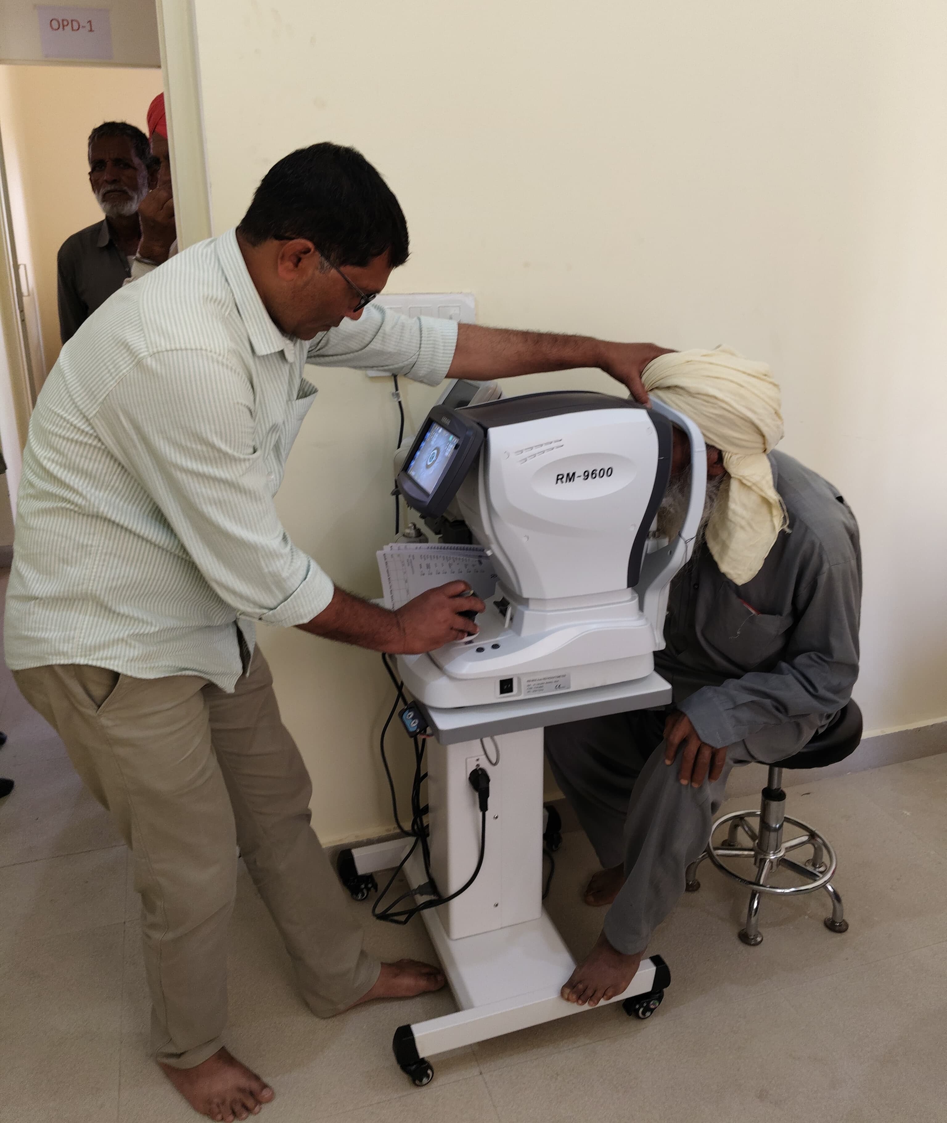 A patient receiving an eye examination using an autorefractor at ARK