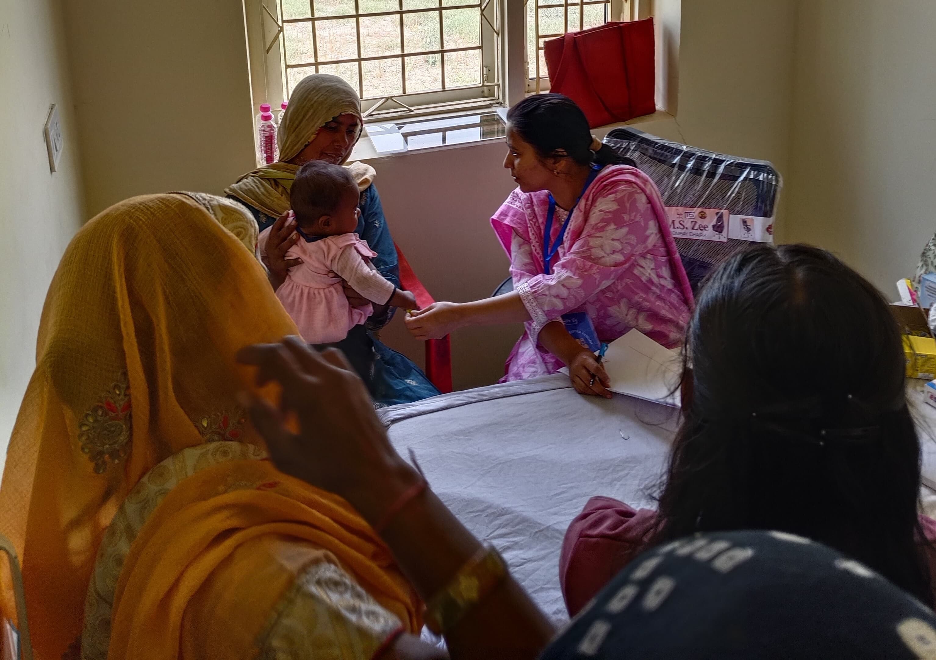 A mother and infant being seen by a healthcare worker at ARK